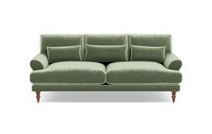 a green couch sitting on top of a white floor