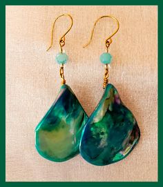 Enjoy a lovely pair of hand made Ocean Design dangle earrings.  These earrings are perfect for ocean lover, or a night out on the town. Each pair of earrings are constructed with love and care. Our earrings are made with Nickle free ear wire. These earrings are hand crafted with shell beads in ocean colors of Teal Blue and Green. Earrings Measure Approx: 1 inch Wide  X  1.50 inches Long If you have any questions prior to purchase please message us through Etsy Thank You! Unique Green Teardrop Earrings For Gift, Ocean-inspired Drop Earrings For Gifts, Ocean-inspired Drop Earrings Gift, Ocean-inspired Drop Earrings For Gift, Ocean-inspired Dangle Single Earring, Ocean-inspired Single Earring As Gift, Ocean-inspired Single Dangle Earring, Handmade Ocean-inspired Drop Earrings, Ocean-inspired Drop Earrings