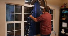 a man working on a window in his home