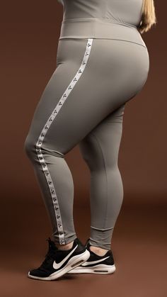 Take your active wear to the next level with this legging. Perfect for an active day at the gym or running errands around the city. This legging comes in a luxurious Nylon/Spandex material that is perfect for smoothing and holding everything in place. Style it up with our V-Neck Top (Grey). Model is wearing a size 18/20 75% Nylon/25% Spandex Fits true to size TMC logo on on each side of the leggings Color may vary due to lighting on images Moisture-wicking Tight Leggings For Streetwear, Micro-elastic Nylon Sportswear Leggings, Compressive Gray Sports Leggings, Gray Compressive Sports Leggings, Sporty Moisture-wicking Mesh Leggings, Stitch Hoodie, Stylish Leggings, Burgundy Leggings, Everyday Leggings