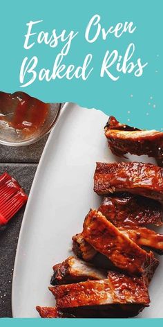 easy oven baked ribs on a white plate with bbq sauce and ketchup