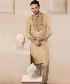 <ul> <li>Color: Peach-Orange</li> <li>Glamorous kurta features exquisite embroidered detail on front, collar and sleeves</li> <li>Complemented with khaki pajama</li> </ul> <p><br /><br /><strong>Additional Accessories:</strong><br />Peshawari Sandal: <strong>US$50</strong><br />Men's Shawl: <strong>US$50</strong></p> Beige Dabka Traditional Wear, Long Sleeve Naqshi Churidar For Traditional Ceremonies, Beige Dabka Traditional Wear For Transitional Season, Unstitched Long Sleeve Beige Kurta, Beige Long Sleeve Traditional Wear For Diwali, Beige Long-sleeve Traditional Wear For Diwali, Transitional Beige Traditional Wear With Dabka, Traditional Beige Lawn Suit For Eid, Brown Traditional Wear With Dabka Work For Eid