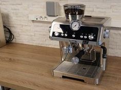 an espresso machine sitting on top of a wooden counter