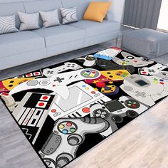 a living room with a couch and rug on the floor that has video game controllers all over it