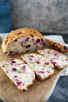 slices of bread with cranberry toppings on a cutting board