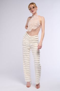 Make some noise for The AKIRA Label City Of Sound Ruffle Pant. These lightweight bottoms feature a super stretchy, sheer composition, a high rise waist with a slight dip front design, an inner elastic waistband, and layered ruffle detailing throughout. Complete with attached inner panty for coverage, a wide leg silhouette, and a pull-on fit. Style with cropped long sleeve tops and peep-toe sandals for a finished look.  - Shell: 90% Nylon 10% Spandex, Lining: 95% Polyester 5% Spandex - Super Stretchy - Imported (all measurements are approximate from size small) - 11” Rise - 31.25” Inseam  - Model is 5’11” Product ID: 396815 (all measurements are approximate from size 1X) - 13” Rise  - 32” Inseam Product ID: 396819 Make Some Noise, All White Party, Cropped Long Sleeve Top, Ruffle Pants, White Accessories, Cropped Long Sleeve, Peep Toe Sandals, White Party, Toe Sandals