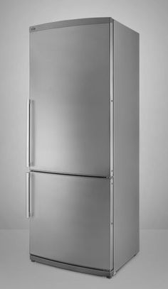 a silver refrigerator freezer sitting on top of a white floor next to a wall