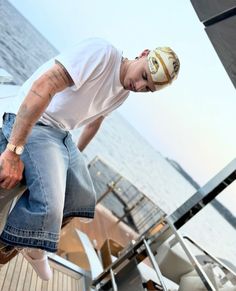 a man in white shirt and jeans on a boat