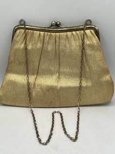 "Fantastic Gold Lame' Vintage Purse with Top Ball Clasp - Gold Chain Handle - Great Evening Bag! Super Vintage Find!! 9\"Wide X 7\" High Condition: Used / Great Vintage Condition / Some wear on gold trim / Slight Stain on Outside - See Pictures I'm crazy about rescuing vintage housewares! I love to locate and then pass on these treasures to someone who will love and value them. I hope that's you 😊 *All of my vintage items are sold as is. *Please take your time to review the photos closely as th Classic Party Bags With Chain Strap, Classic Gold Shoulder Bag For Gift, Classic Gold Shoulder Bag As Gift, Classic Gold Evening Bag As Gift, Classic Gold Evening Bag For Gift, Classic Party Bag With Chain Detail, Classic Party Bag With Chain, Vintage Gold Bag With Chain, Classic Gold Bag With Chain Detail