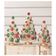 three small christmas trees sitting on top of each other