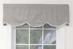 a window with a curtain that has a waterfall on it