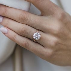 a woman's hand with a diamond ring on it