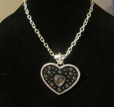 Black and silver toned heart pendant fashion necklace measuring 16" from end to end with a sturdy clasp and ready for wear Silver Gothic Heart Necklace, Black Heart Pendant Edgy Jewelry, Punk Style Black Heart Pendant Necklace, Edgy Silver Heart-shaped Necklace, Grunge Heart-shaped Metal Necklace, End To End, Black And Silver, Heart Pendant, High Tops