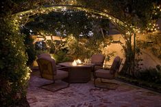 an outdoor patio with lights and chairs