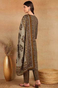 Grab this beautiful 3-piece set. The set comes with ethnic motif print detailing straight shape kurta has round neck, 3/4th sleeves & calf length teamed with printed trouser pant with single pocket and a printed dupatta. Color - Brown Kurta Fabric-Cotton Blend Pant Fabric-Cotton Blend Dupatta Fabric - Cotton Blend Neck-Round Neck Sleeves-3/4th Sleeves Work - Ethnic Motif Print Detailing Washing Instructions-Dry Clean Model Height - 5.5 wearing size small. DISCLAIMER - The color of the product ma