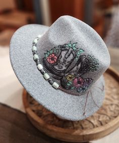 Felt/wool hat hand burned with cowgirl boots and floral pattern. Hand colored and hand made beaded band. Adjustable and nice quality. beautiful soft heathered gray color ... fun for any event, awesome gift! Handmade Fedora Hats For Country Events, Handmade Brimmed Fedora For Festivals, Handmade Fedora For Country Events, Rustic Adjustable Felt Hat For Festival, Handmade Short Brim Fedora For Festival, Country Style Fedora For Winter Events, Artisan Fedora For Country Events, Country Style Fedora For Winter Country Events, Handmade Rustic Hat Band