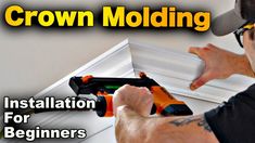 a man is installing a crown molding system for windows and trimming the ceiling