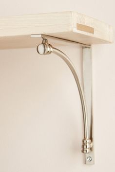 a close up of a wall mounted shelf with a light fixture on it's side