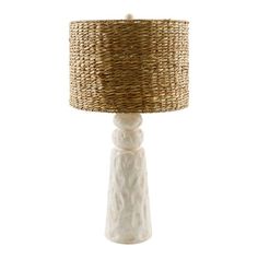 a white table lamp with a wicker shade