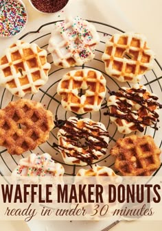 several waffles on a wire rack with chocolate sauce and sprinkles