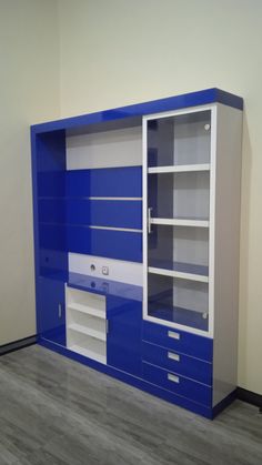 a blue and white entertainment center in an empty room