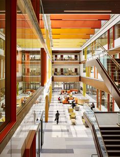 the interior of an office building with people walking around