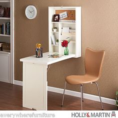 a small desk with a chair next to it and a clock on the wall behind it