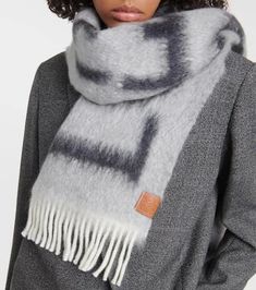 Material: 49% wool, 47% mohair, 4% polyamide.Care instructions: dry clean.Made in Italy.Designer color name: Light Grey/Dark Grey.Contains non-textile parts of animal origin.Length 180cm-71'.Width 24cm-9.5'.Length of fringe 9cm-3.5' Gray Wool Scarf For Fall, Winter Mohair Scarves, Loewe Anagram, Shop Logo, Wool Scarf, Color Names, Silk Printing, Silk Scarf, Scarf Wrap