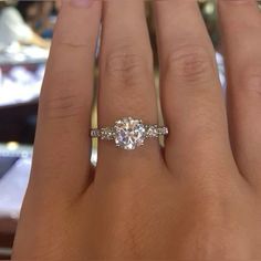 a woman's hand with two engagement rings on it