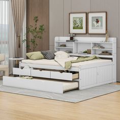 a white bed sitting on top of a wooden floor