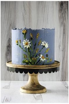 a blue cake with white flowers on it