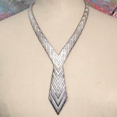 "Rare 1970s silver necklace formed into the shape of a tie. The necklace has an interesting chevron design throughout. Jewellery of the 1970s was bold and beautiful with a hint of decadence - summed up perfectly in this usual necklace. Paired with a shirt or a dress this necklace will make a strong statement. Details Length: circumference of necklace part; 45 cm; length of \"tie\" drop 9.5cm Weight: 94g Age: 1970s Materials Silver (stamped 925) Condition Notes Good used condition" Peacock Pendant, Silver Tie, Chevron Necklace, Woven Necklace, Tie Necklace, Jewelry Knots, Pearl And Diamond Ring, Solid Gold Necklace, Ribbon Necklace