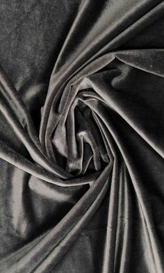 a black and white photo of an up close shot of a plain fabric with very thin folds