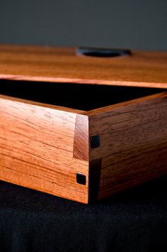 a wooden box sitting on top of a black cloth