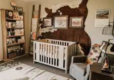 a baby's room with an animal themed wall