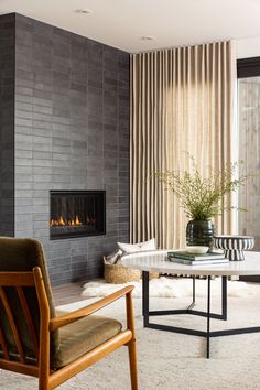 a living room filled with furniture and a fire place next to a wall mounted fireplace