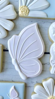 decorated cookies are arranged on a white table