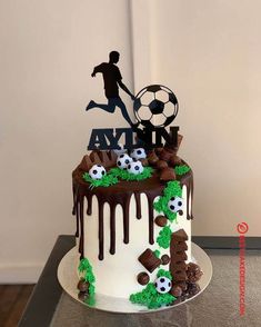 a soccer themed birthday cake with chocolate icing and fondant decorations on the top