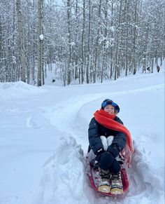 a child sledding down a hill in the snow