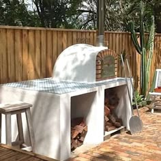 an outdoor pizza oven with wood in it