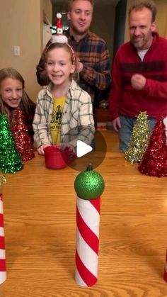 a group of people sitting around a table with candy canes