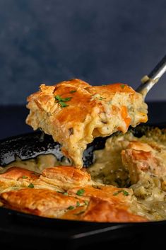 a piece of broccoli and cheese casserole being lifted from a skillet