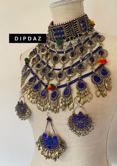 Exquisite Afghan Ethnic Jewelry - Handcrafted Tribal Elegance Original sets Explore the timeless beauty and intricate craftsmanship of our Afghan ethnic jewelry collection at Dipdaz. Each piece in our collection is a unique work of art, meticulously handcrafted by skilled artisans using traditional techniques passed down through generations. Our jewelry features a stunning array of vibrant gemstones, intricate metalwork, and authentic tribal designs, making every piece a true statement of cultur Ceremonial Blue Jewelry With Intricate Design, Afghan Jewelry Vintage, Traditional Metal Jewelry For Navratri, Ornate Metal Jewelry For Festivals, Ceremonial Hand-set Jewelry For Navratri, Ceremonial Hand Set Jewelry For Navratri, Hand Set Ceremonial Jewelry For Navratri, Bohemian Bridal Necklace For Ceremonial Festivals, Bohemian Brass Jewelry With Meenakari