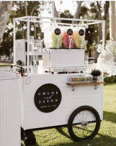 an ice cream cart is decorated with flowers and candles for the wedding guests to enjoy