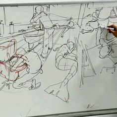 a person is drawing on a whiteboard with red marker in front of them and people around it