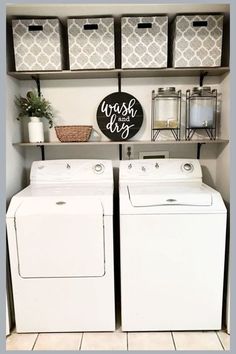 a washer and dryer sitting in a room next to some shelves with baskets on them