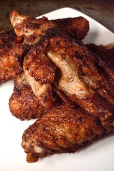 some chicken wings on a white plate