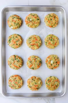 freshly baked carrot and spinach cookies on a baking sheet ready to go into the oven