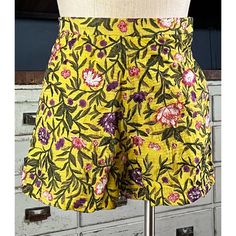 New With Tags Size Xs These Stunning Shorts By Anthropologie In Collaboration With La Fuori Have Intricate Floral Embroidery On A Deep Yellow Background. The High Rise Shorts Have A Modest Cut. The Fabric Is 65% Cotton, 30% Silk, & 5% Metallic Fibers. The Yellow Fabric Is Interwoven With Beautiful Metallic Gold Fibers. They Have A Hidden Side Zipper. *The Shorts Are Not Zipped Up All Of The Way On The Dress Form. The Zipper Is Fully Functional & Works Perfectly. Measurements Laying Flat: Length Yellow Bottoms With Floral Embroidery For Summer, Yellow Floral Embroidered Bottoms For Summer, Yellow Floral Embroidery Bottoms For Summer, Spring Yellow Bottoms With Floral Embroidery, Yellow Floral Embroidery Bottoms For Spring, Fitted Floral Embroidered Bottoms For Vacation, Floral Print Cotton Shorts, Fitted Cotton Shorts With Floral Print, Fitted Floral Print Cotton Shorts