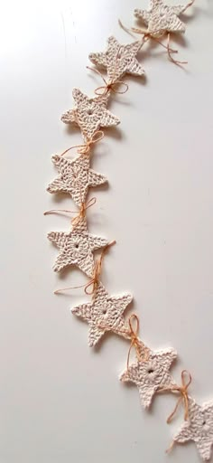 some white crocheted stars are tied together